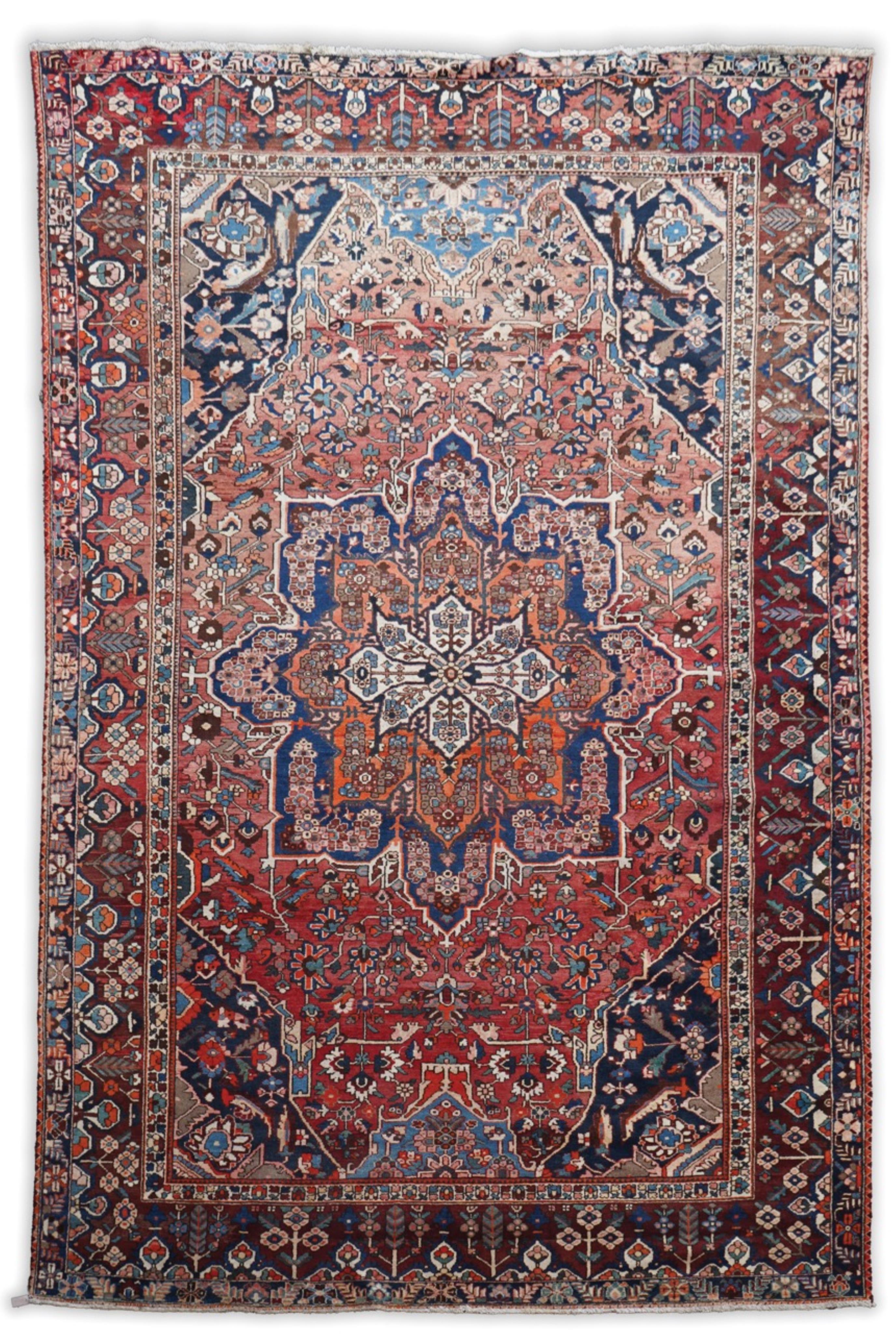 A Heriz brick red ground carpet